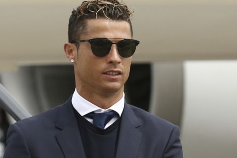 Cristiano Ronaldo of Real Madrid arrives with his teammates at Cardiff airport, Wales, Friday June 2, 2017. Real Madrid will play Juventus in the final of the Champions League soccer match in Cardiff on Saturday. (UEFA Pool via AP)