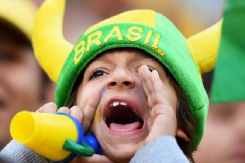 SAO PAULO, BRAZIL - JUNE 12:  A young fan cheers before the 2014 FIFA World Cup Brazil Group A match between Brazil and Croatia at Arena de Sao Paulo on June 12, 2014 in Sao Paulo, Brazil.  (Photo by Christopher Lee/Getty Images)