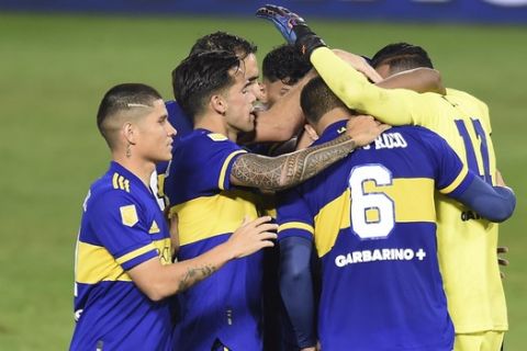 Boca Juniors players celebrate after defeating River Plate in a local league soccer match at the Bombonera stadium in Buenos Aires, Argentina, Sunday, May 16, 2021. (Marcelo Endelli/Pool via AP)