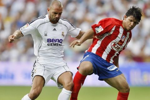 Real Madrid Raul Bravo, left, player duels for the ball with Atletico de Madrid Sergio Aguero player during their Spanish league soccer match at the Santiago Bernabeu Stadium in Madrid, Sunday, Oct. 1, 2006. (AP Photo/Jasper Juinen)