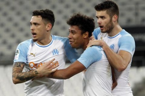 Marseille's Boubacar Kamara, center, celebrates his side first goal with teammates Lucas Ocampos, left, and Duje Caleta-Car during the French League One soccer match between Marseille and Bordeaux at the Velodrome Stadium, in Marseille, Tuesday, Feb. 5, 2019. (AP Photo/Claude Paris)