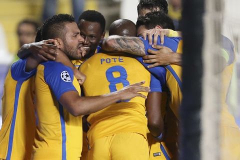 APOEL Nicosia's Mickael Pote celebrates with his teammates after scoring the opening goal during the Champions League Group H soccer match between APOEL Nicosia and Borussia Dortmund at GSP stadium, in Nicosia, Cyprus, on Tuesday, Oct. 17, 2017. (AP Photo/Petros Karadjias)