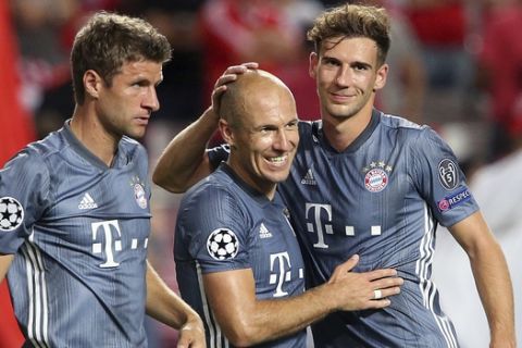 Munich players Thomas Mueller, Arjen Robbenand Leon Goretzka, from left, celebrate after the Champions League group E soccer match between Benfica and Bayern Munich at the Luz stadium in Lisbon, Wednesday, Sept. 19, 2018. (AP Photo/Armando Franca)