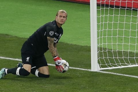 Liverpool goalkeeper Loris Karius holds the ball after Real Madrid's Gareth Bale scored his side's 2nd goal during the Champions League Final soccer match between Real Madrid and Liverpool at the Olimpiyskiy Stadium in Kiev, Ukraine, Saturday, May 26, 2018. (AP Photo/Darko Vojinovic)