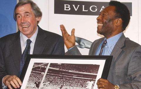 Brazilian soccer legend Pele, right, presents former England goalkeeper Gordon Banks with a photograph showing Banks saving a header from Pele in the 1970 World Cup, at a press conference in London, Thursday March 4, 2004, to mark FIFA's 100 year anniversary. (AP Photo/Max Nash)
