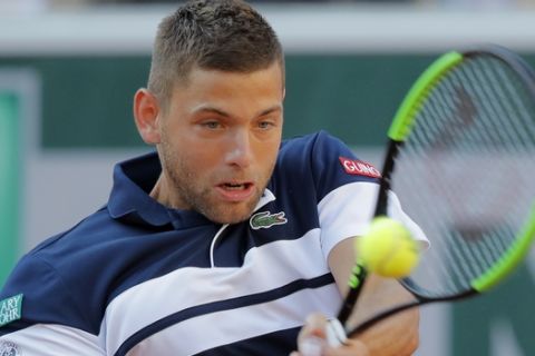 Serbia's Filip Krajinovic plays a shot against Greece's Stefanos Tsitsipas during their third round match of the French Open tennis tournament at the Roland Garros stadium in Paris, Friday, May 31, 2019. (AP Photo/Michel Euler)