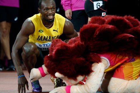 Jamaica's Usain Bolt smiles next to mascot Hero the Hedgehog after his men's 100m heat the World Athletics Championships in London Friday, Aug. 4, 2017. (AP Photo/Matthias Schrader)