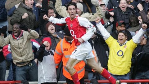 Arsenal's Robert Pires celebrates scoring against Sheffield United during their fifth round FA Cup soccer match at Arsenal's Highbury ground in London, Saturday Feb. 19, 2005. The match ended in a 1-1 draw. (AP Photo/Alastair Grant)