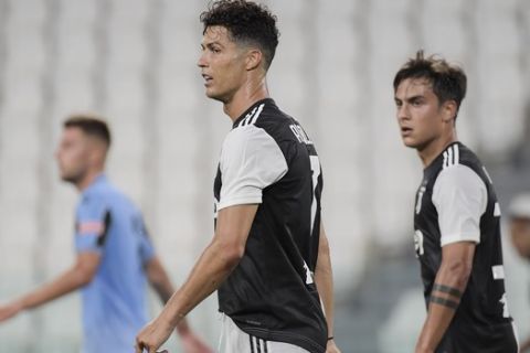 Juventus' Cristiano Ronaldo, center, and Paulo Dybala watch play during the Italian Serie A soccer match between Juventus and Lazio at the Allianz stadium in Turin, Italy, Monday, July 20, 2020. (Marco Alpozzi/LaPresse via AP)