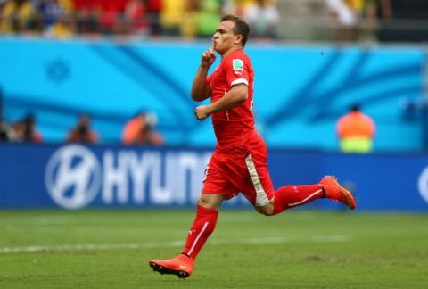 MANAUS, BRAZIL - JUNE 25: Xherdan Shaqiri of Switzerland celebrates scoring his team's first goal during the 2014 FIFA World Cup Brazil Group E match between Honduras and Switzerland at Arena Amazonia on June 25, 2014 in Manaus, Brazil.  (Photo by Clive Mason - FIFA/FIFA via Getty Images)