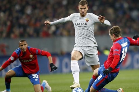 Roma forward Edin Dzeko, left, is tackled by CSKA defender Kirill Nababkin during a Group G Champions League soccer match between CSKA Moscow and Roma at the Luzhniki Stadium in Moscow, Wednesday, Nov. 7, 2018. (AP Photo/Pavel Golovkin)