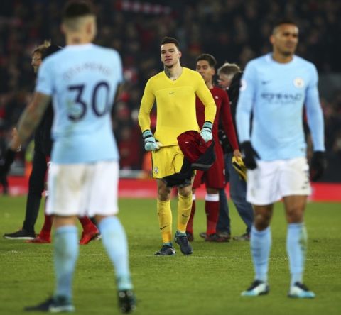 Manchester City's goalkeeper Ederson, center, walks to the center of the pitch after the English Premier League soccer match between Liverpool and Manchester City at Anfield Stadium, in Liverpool, England, Sunday Jan. 14, 2018. (AP Photo/Dave Thompson)