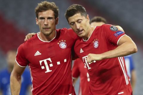 Bayern's Robert Lewandowski, right, celebrates with teammate Leon Goretzka after scoring his team's first goal from the penalty spot during the Champions League round of 16 second leg soccer match between Bayern Munich and Chelsea at Allianz Arena in Munich, Germany, Saturday, Aug. 8, 2020. (AP Photo/Matthias Schrader)
