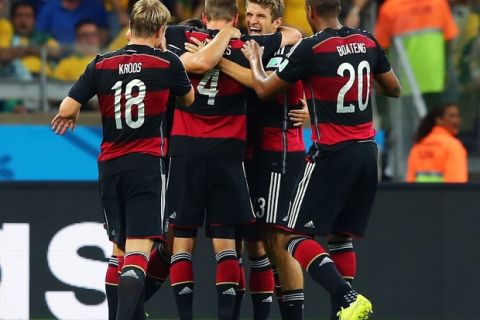 BELO HORIZONTE, BRAZIL - JULY 08: Sami Khedira of Germany (obscured) celebrates scoring his team's fifth goal with teammates Toni Kroos, Benedikt Hoewedes, Thomas Mueller and Jerome Boateng during the 2014 FIFA World Cup Brazil Semi Final match between Brazil and Germany at Estadio Mineirao on July 8, 2014 in Belo Horizonte, Brazil.  (Photo by Martin Rose/Getty Images)