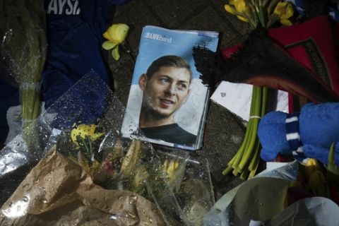 Tributes are placed outside the Cardiff City Stadium, Wales, for Emiliano Sala, Friday Feb. 8, 2019. Tributes are being paid across soccer to Argentine player Emiliano Sala, with the French league announcing a minute's applause before matches. French club Nantes says it will retire the No. 9 jersey worn by Sala before he was sold last month to Cardiff in the English Premier League. (Aaron Chown/PA via AP)