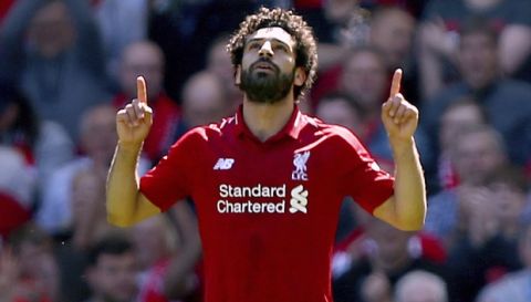Liverpool's Mohamed Salah celebrates scoring his side's first goal of the game during their English Premier League soccer match against Brighton & Hove Albion at Anfield, Liverpool. England, Sunday, May 13, 2018. (Dave Thompson/PA via AP)
