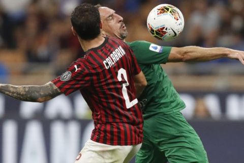 AC Milan's Davide Calabria, left, and Fiorentina's Franck Ribery fight for the ball during a Serie A soccer match between AC Milan and Fiorentina, at the San Siro stadium in Milan, Italy, Sunday, Sept. 29, 2019. (AP Photo/Antonio Calanni)