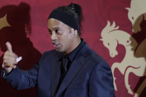 Brazilian soccer star and former FC Barcelona player Ronaldinho arrives for the the 2018 soccer World Cup draw in the Kremlin in Moscow, Friday, Dec. 1, 2017. (AP Photo/Dmitri Lovetsky)
