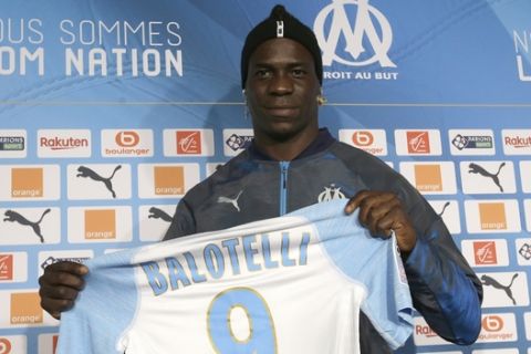 FILE - In this file photo dated Wednesday, Jan. 23, 2019, Olympique Marseille's new player Mario Balotelli poses during a press conference, at the club's headquarters of La Commanderie, in Marseille, southern France. The French club Marseille, is out of European competition after a fifth-place finish in Ligue 1, despite an attack that includes Mario Balotelli, and now Marseille must pay UEFA 2 million euros ($2.24 million) for breaking financial fair play rules, according to a UEFA announcement Wednesday June 19, 2019. (AP Photo/Claude Paris, FILE )