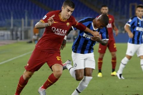 Roma's Gianluca Mancini, left, and Inter Milan's Ashley Young challenge for the ball during the Serie A soccer match between Roma and Inter Milan, at the Rome Olympic Stadium, Sunday, July 19, 2020. (AP Photo/Riccardo De Luca)