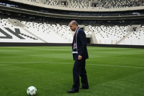 In this Sunday, April 10, 2016 photo Turkeys President Recep Tayyip Erdogan kicks a soccer ball during the opening ceremony of Besiktas new stadium, Vodafone Arena, in Istanbul. No fans were allowed however, for the opening of the stadium of Besiktas, one of Turkeys three leading soccer clubs. Media reports said the move was aimed to avoid possible protest against Erdogan. (Basin Bulbul, Presidential Press Service Pool via AP)