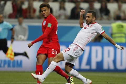 England's Dele Alli, left, and Tunisia's Ali Maaloul challenge for the ball during the group G match between Tunisia and England at the 2018 soccer World Cup in the Volgograd Arena in Volgograd, Russia, Monday, June 18, 2018. (AP Photo/Frank Augstein)