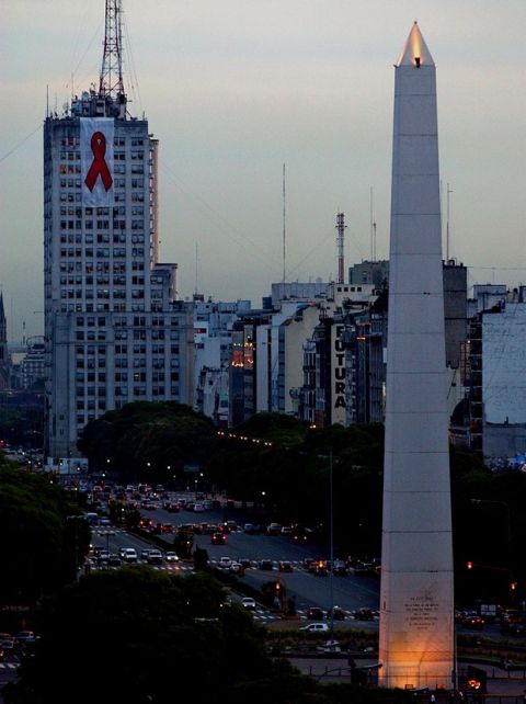 A red ribbon, the symbol of the campaign against AIDS, hangs on the Health Ministry to commemorate World Aids Day in Buenos Aires, Argentina, Monday, Dec.1, 2003. According to official figures, approximately 27,000 people in Argentina have AIDS/HIV. At the right, the Obelisco monument. (AP Photo/Natacha Pisarenko)