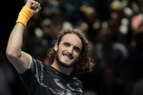 Stefanos Tsitsipas of Greece celebrates winning match point against Roger Federer of Switzerland during their ATP World Tour Finals semifinal tennis match at the O2 Arena in London, Saturday, Nov. 16, 2019. (AP Photo/Kirsty Wigglesworth)