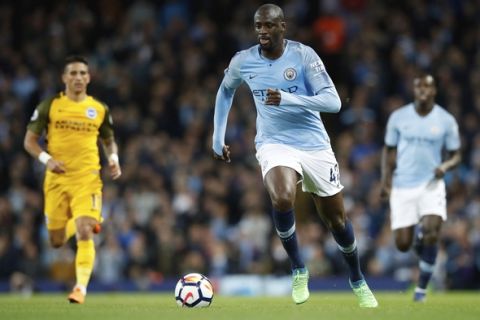 Manchester City's Yaya Toure controls the ball during the English Premier League soccer match against Brighton & Hove Albion at the Etihad Stadium, Manchester, England, Wednesday May 9, 2018. (Martin Rickett/PA via AP)