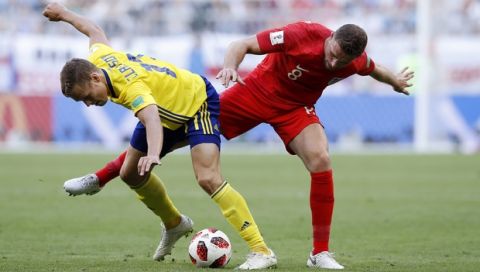 England's Jordan Henderson, right, challenges for the ball with Sweden's Viktor Claesson during the quarterfinal match between Sweden and England at the 2018 soccer World Cup in the Samara Arena, in Samara, Russia, Saturday, July 7, 2018. (AP Photo/Alastair Grant)
