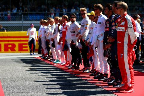 MONZA, ITALY - SEPTEMBER 06:  The drivers stand for the national anthem on the grid before the Formula One Grand Prix of Italy at Autodromo di Monza on September 6, 2015 in Monza, Italy.  (Photo by Dan Istitene/Getty Images)
