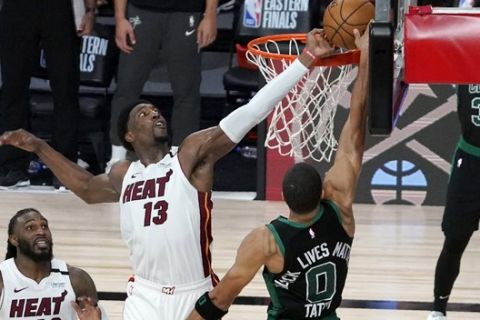 Miami Heat's Jimmy Butler, bottom left, and Jae Crowder (99) look on as Bam Adebayo (13) blocks a shot attempt by Boston Celtics' Jayson Tatum (0) in the closing seconds of overtime of an NBA conference final playoff basketball game, Tuesday, Sept. 15, 2020, in Lake Buena Vista, Fla. (AP Photo/Mark J. Terrill)