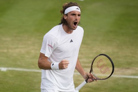 Stefanos Tsitsipas of Greece celebrates winning the second set against Serbia's Laslo Djere in a men's singles match on day six of the Wimbledon tennis championships in London, Saturday, July 8, 2023. (AP Photo/Kirsty Wigglesworth)