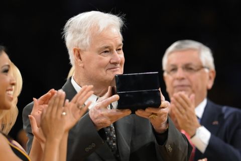 FILE - In this Oct. 27, 2009, file photo, Los Angeles Lakers assistant coach Tex Winter receives his NBA championship ring during the second half of the team's NBA basketball game against the Los Angeles Clippers in Los Angeles. At rear is NBA Commissioner David Stern. (AP Photo/Gus Ruelas, File)