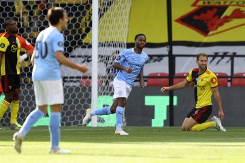 Manchester City's Raheem Sterling, centre, celebrates after scoring his side's opening goal during the English Premier League soccer match between Watford and Manchester City at the Vicarage Road Stadium in Watford, England, Tuesday, July 21, 2020. (Richard Heathcote/Pool via AP)