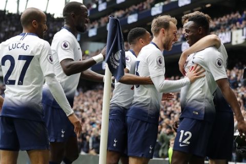 Tottenham's Victor Wanyama, right, celebrates with his teammates after scoring his side's opening goal during the English Premier League soccer match between Tottenham Hotspur and Huddersfield Town at Tottenham Hotspur stadium in London, Saturday, April 13, 2019.(AP Photo/Frank Augstein)