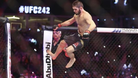 Russian UFC fighter Khabib Nurmagomedov, jumps during Lightweight title mixed martial arts bout at UFC 242, fight against UFC fighter Dustin Poirier, of Lafayette, La., in Yas Mall in Abu Dhabi, United Arab Emirates, Saturday , Sept.7 2019. (AP Photo/ Mahmoud Khaled)
