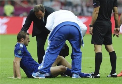 Greece's Avraam Papadopoulos gets medical treatment after being injured  during the Euro 2012 soccer championship Group A match between Poland and Greece in Warsaw, Poland, Friday, June 8, 2012. (AP Photo/Alik Keplicz) 