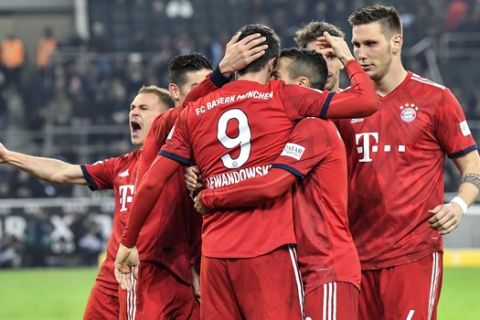 Bayern's Robert Lewandowski celebrates with his team after he scored his side's third goal during the German Bundesliga soccer match between Borussia Moenchengladbach and FC Bayern Munich in Moenchengladbach, Germany, Saturday, March 2, 2019. (AP Photo/Martin Meissner)