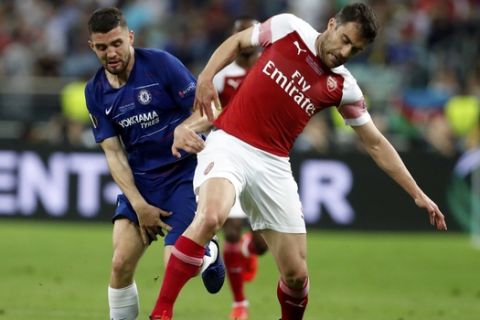 Chelsea's Mateo Kovacic fights for the ball with Arsenal's Sokratis Papastathopoulos, right, during the Europa League Final soccer match between Chelsea and Arsenal at the Olympic stadium in Baku, Azerbaijan, Wednesday, May 29, 2019. (AP Photo/Darko Bandic)