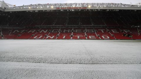 Snow on the pitch ahead of the English FA Cup quarterfinal soccer match between Manchester United and Brighton, at the Old Trafford stadium in Manchester, England, Saturday, March 17, 2018. (AP Photo/Frank Augstein)