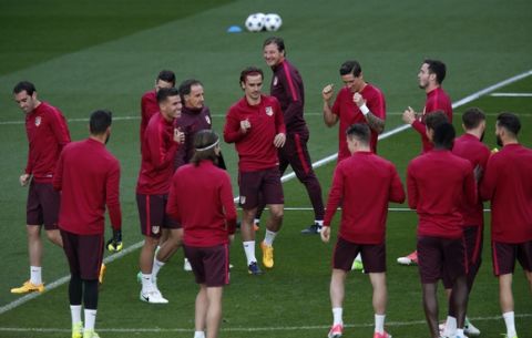 Atletico Madrid players gather at the middle of the pitch during a training session at the Santiago Bernabeu stadium in Madrid, Monday, May 1, 2017. Atletico Madrid will play a Champions League first leg semifinal soccer match against Real Madrid on Tuesday 2. (AP Photo/Francisco Seco)