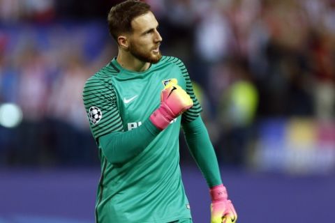 FILE - In this Wednesday, April 12, 2017 file photo, Atletico goalkeeper Jan Oblak celebrates after teammate Antoine Griezmann scoring the opening goal during the Champions League quarterfinal first leg soccer match between Atletico Madrid and Leicester City at the Vicente Calderon stadium in Madrid. The Champions League semifinals begin this week with Spanish rivals Real Madrid and Atletico Madrid meeting for the fourth consecutive time in the European competition, while surprising French club Monaco will try to keep Italian champion Juventus from returning to the final for the second time in three seasons. (AP Photo/Francisco Seco, File)