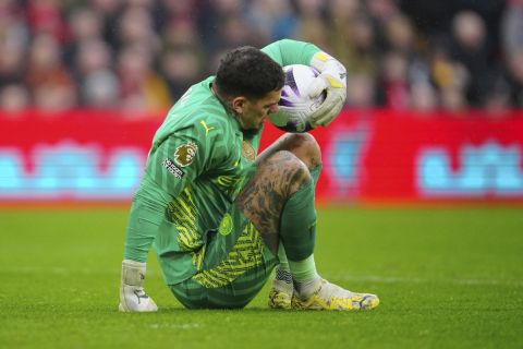 Manchester City's goalkeeper Ederson reacts after an injuring during the English Premier League soccer match between Liverpool and Manchester City, at Anfield stadium in Liverpool, England, Sunday, March 10, 2024. (AP Photo/Jon Super)