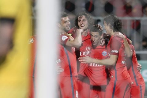 Paris Saint Germain's forward Angel Di Maria, center, celebrates with teammates after scoring the second goal during his French League One soccer match against Angers, in Angers, western France, Friday, April 14, 2017. Paris won 2-0. (AP Photo/David Vincent)