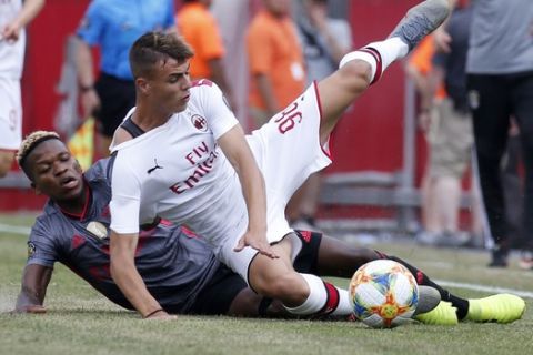 Benfica's Florentino Luis slides in from behind as he defends AC Milan's Daniel Maldini during the second half of an International Champions Cup soccer match, Sunday, July 28, 2019, in Foxborough, Mass. (AP Photo/Mary Schwalm)