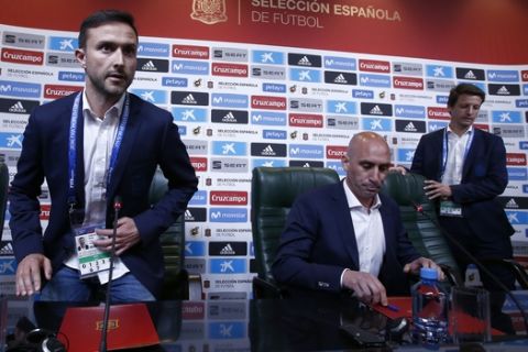 Spanish football president Luis Rubiales, center, attends a press conference at the 2018 soccer World Cup in Krasnodar, Russia, Wednesday, June 13, 2018. The Spanish soccer federation has fired coach Julen Lopetegui two days before the country's opening World Cup match against Portugal. Lopetegui was let go a day after Real Madrid announced him as its new coach following the World Cup. (AP Photo/Manu Fernandez)