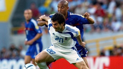 Georgios Karagounis, front, of Greece,  protects the ball head of Olivier Dacourt, of France, during the Euro 2004 quarterfinal soccer match between France and Greece at the Jose Alvalade stadium in Lisbon, Portugal, Friday, June 25, 2004. (AP Photo/Luca Bruno) **  FOR EDITORIAL USE ONLY NO WIRELESS COMMERCIAL OR PROMOTIONAL LICENSING PERMITTED  **