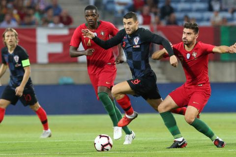 Croatia's Mateo Kovacic vies for the ball with Portugal's Ruben Neves, right, during the international friendly soccer match between Portugal and Croatia at the Algarve stadium, outside Faro, Portugal, Thursday, Sept. 6, 2018. (AP Photo/Armando Franca)