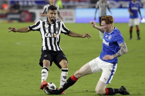 Glasgow Rangers' David Bates, right, tries to steal the ball from Atletico Mineiro's Thalis during the second half of a Florida Cup soccer match Thursday, Jan. 11, 2018, in Orlando, Fla. The Rangers won 1-0. (AP Photo/John Raoux)
